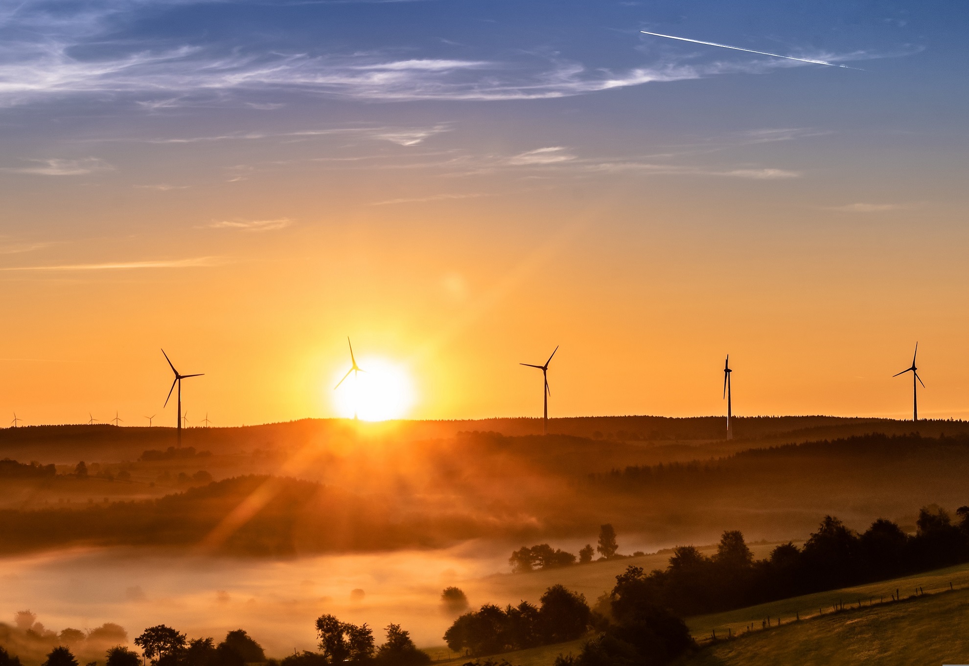 Photo of wind turbines in sunset