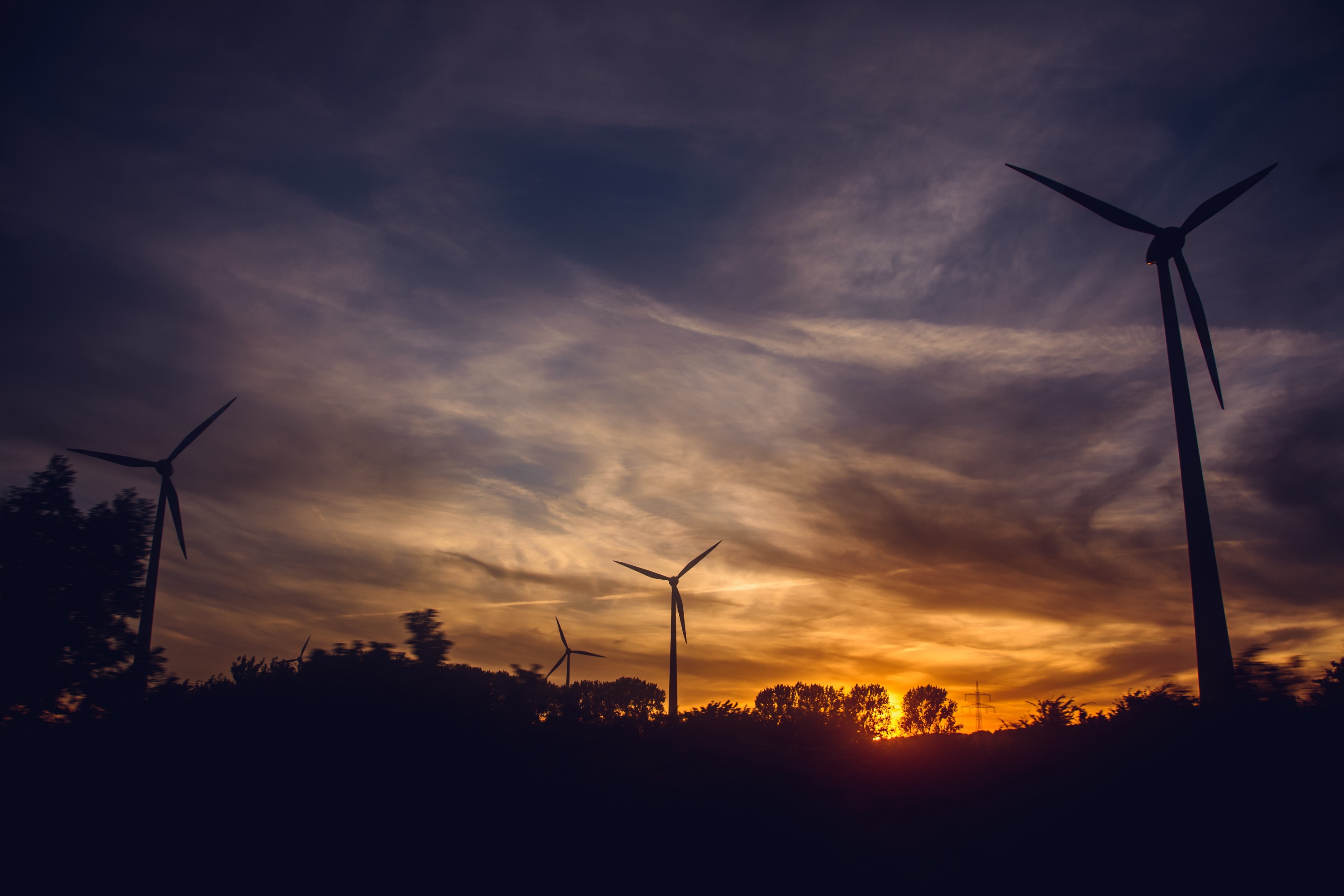Photo of wind turbines after sunset